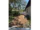 The backyard features mature trees, mixed fencing, and an HVAC unit at 261 Deleon Rd, Debary, FL 32713