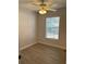 This bedroom features a ceiling fan, a window with blinds, and wood-look flooring at 261 Deleon Rd, Debary, FL 32713
