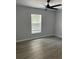 Bedroom with wood-look floors, light gray walls, black ceiling fan and natural light at 261 Deleon Rd, Debary, FL 32713