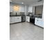 Well-lit kitchen with stainless steel appliances, white cabinetry, and a modern faucet at 261 Deleon Rd, Debary, FL 32713