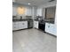 Well-lit kitchen with stainless steel appliances, white cabinetry, and a modern faucet at 261 Deleon Rd, Debary, FL 32713