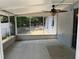 This screened patio features a ceiling fan and has views of the yard at 261 Deleon Rd, Debary, FL 32713