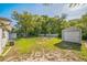 Spacious backyard with lush green grass and a detached storage shed at 2647 S Myrtle Ave, Sanford, FL 32773