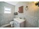 Stylish bathroom with gray-tone walls, modern vanity, and decorative mirror at 2647 S Myrtle Ave, Sanford, FL 32773