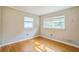 Inviting bedroom with hardwood floors and two windows for natural light at 2647 S Myrtle Ave, Sanford, FL 32773