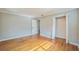 Large bedroom featuring hardwood floors, closet, and adjacent entrance at 2647 S Myrtle Ave, Sanford, FL 32773