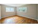 Bedroom featuring hardwood floors, two windows, and neutral colored walls at 2647 S Myrtle Ave, Sanford, FL 32773
