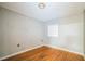 Cozy bedroom with hardwood floors, single window, and neutral colored walls at 2647 S Myrtle Ave, Sanford, FL 32773