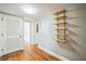 Hallway features hardwood flooring, open shelving, and access to multiple rooms at 2647 S Myrtle Ave, Sanford, FL 32773