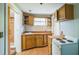 Compact kitchen with ample counter space, wooden cabinets, and classic range at 2647 S Myrtle Ave, Sanford, FL 32773
