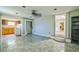 Open living room with tile flooring connecting to a kitchen with wooden cabinets at 2647 S Myrtle Ave, Sanford, FL 32773