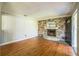 Inviting living room featuring a stone fireplace, wood floors, and ample space for comfortable living at 2647 S Myrtle Ave, Sanford, FL 32773