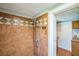 Tiled shower with decorative trim, a showerhead, and a built-in niche at 2647 S Myrtle Ave, Sanford, FL 32773