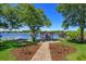 Backyard with lake, dock, gazebo, pergola, and brick path at 2828 Marquesas Ct, Windermere, FL 34786