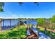 A backyard leads to a dock on the lake with a boat house and gazebo at 2828 Marquesas Ct, Windermere, FL 34786