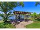 Lakeside patio, gazebo, boat dock and lush green backyard at 2828 Marquesas Ct, Windermere, FL 34786