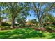Sprawling backyard with manicured lawn, mature trees and shrubs at 2828 Marquesas Ct, Windermere, FL 34786