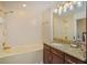 Bathroom featuring tile surround bathtub and granite vanity countertop at 2828 Marquesas Ct, Windermere, FL 34786