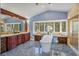 Luxurious bathroom with marble floors, a soaking tub, vanity, and a large window with private outdoor views at 2828 Marquesas Ct, Windermere, FL 34786
