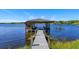 Inviting boat dock with a covered boat slip and stunning lake views at 2828 Marquesas Ct, Windermere, FL 34786