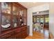 Bright dining room featuring hardwood floors, glass doors and mahogany china cabinet for showcasing decor at 2828 Marquesas Ct, Windermere, FL 34786