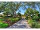 Tree lined driveway leading to an impressive brick home with mature landscaping at 2828 Marquesas Ct, Windermere, FL 34786