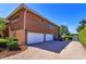 Exterior view of the red brick home with a paved driveway and garage at 2828 Marquesas Ct, Windermere, FL 34786