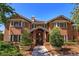 Charming two-story red brick home with meticulously maintained landscaping and covered entryway at 2828 Marquesas Ct, Windermere, FL 34786