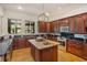 Gourmet kitchen with cherry cabinets, granite countertops, and stainless steel appliances at 2828 Marquesas Ct, Windermere, FL 34786