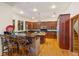 Gourmet kitchen with wood cabinets, granite countertops, and a breakfast bar at 2828 Marquesas Ct, Windermere, FL 34786