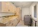 Laundry Room featuring tile floors, washer and dryer, and custom storage cabinets at 2828 Marquesas Ct, Windermere, FL 34786