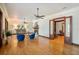Bright living room features hardwood floors, fireplace, ceiling fans and French doors at 2828 Marquesas Ct, Windermere, FL 34786