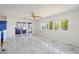 Bright and open living room with large windows showcasing a lake view and marble floors throughout at 2828 Marquesas Ct, Windermere, FL 34786