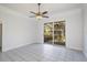 Open living room with tile floors and sliding glass doors to the patio, providing ample natural light at 2828 Marquesas Ct, Windermere, FL 34786