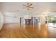 Open living room featuring a fireplace, ceiling fans, wood floors, and neutral walls with ample natural light at 2828 Marquesas Ct, Windermere, FL 34786