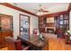 Office space featuring built-in cabinets, a brick fireplace, and hardwood floors at 2828 Marquesas Ct, Windermere, FL 34786