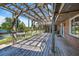 Open patio featuring wooden pergola, offering stunning views of lake and grounds at 2828 Marquesas Ct, Windermere, FL 34786