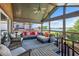 Comfortable screened patio with plush seating and picturesque lake view at 2828 Marquesas Ct, Windermere, FL 34786