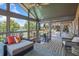 Relaxing screened patio area with scenic lake views and comfortable lounge seating at 2828 Marquesas Ct, Windermere, FL 34786