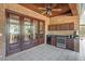 Brick patio with tiled floor, outdoor kitchen and french doors leading into the house at 2828 Marquesas Ct, Windermere, FL 34786