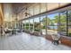 Enclosed patio with tiled floor, dining area, spiral staircase and a view of the pool and lake at 2828 Marquesas Ct, Windermere, FL 34786