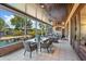 Covered patio with tiled flooring, outdoor dining, and views of the pool and gardens at 2828 Marquesas Ct, Windermere, FL 34786