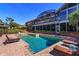 Backyard pool with brick surround, lounge chairs, and a view of the home at 2828 Marquesas Ct, Windermere, FL 34786