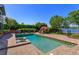 Backyard pool, with brick surround, lush landscaping, and a lake view at 2828 Marquesas Ct, Windermere, FL 34786