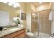 Bathroom with granite counters, a shower with glass door, toilet and updated fixtures at 2919 Banana Palm Dr, Kissimmee, FL 34747