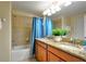 Updated bathroom with double sinks, granite countertops, and tiled shower and tub at 2919 Banana Palm Dr, Kissimmee, FL 34747