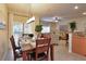 Dining area open to the living room and kitchen with patio access and seating for six at 2919 Banana Palm Dr, Kissimmee, FL 34747
