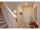 Home foyer featuring stairs, door to bathroom, entrance door, and decor at 2919 Banana Palm Dr, Kissimmee, FL 34747