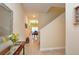 Hallway features tile flooring, stairway, decor, with a view of the dining room at the end at 2919 Banana Palm Dr, Kissimmee, FL 34747