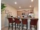 Kitchen featuring bar seating, stainless steel appliances, and granite countertops at 2919 Banana Palm Dr, Kissimmee, FL 34747